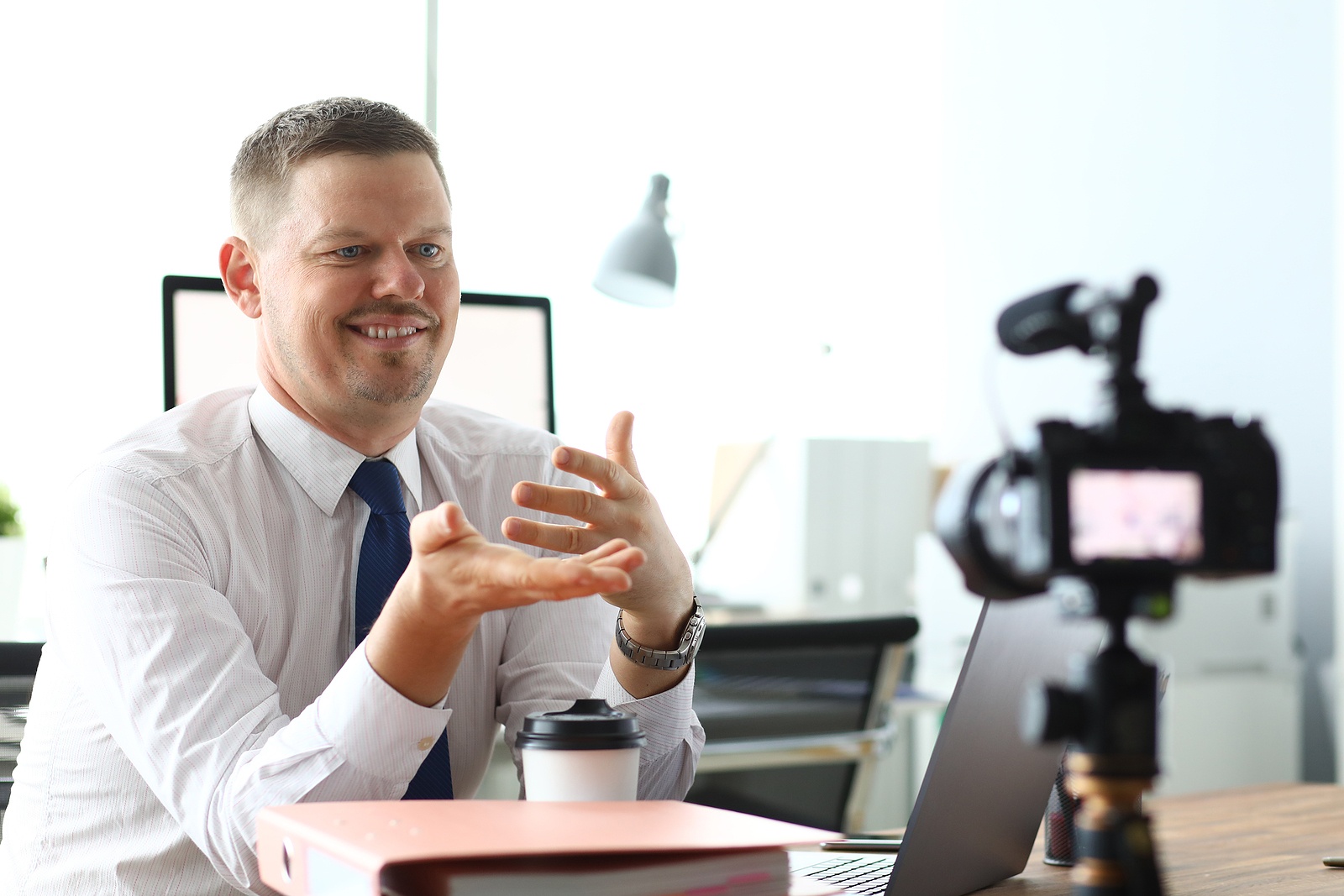 Business man recording a video representing Content Marketing: Financial advisor making a video